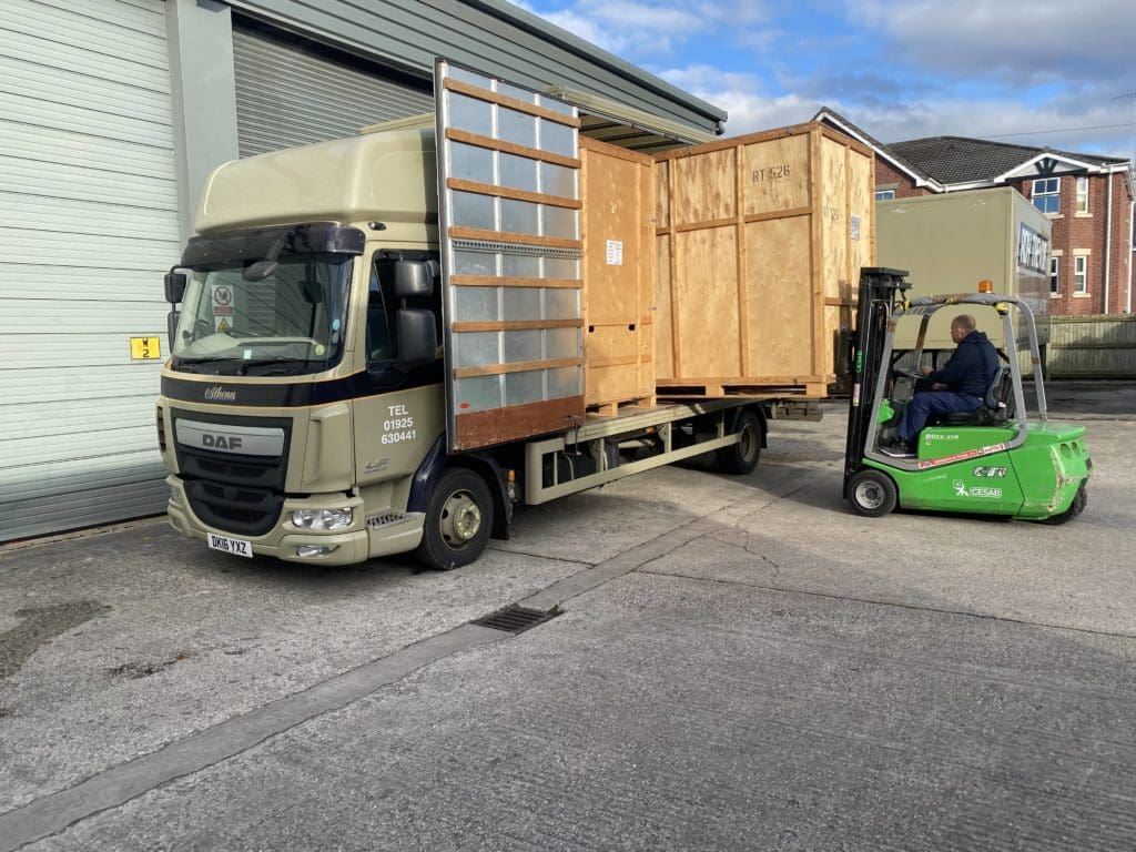 Fork lift truck unloading wooden crates