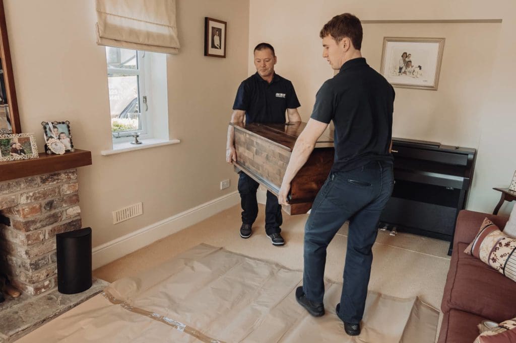 Roy Trevor team lifting furniture