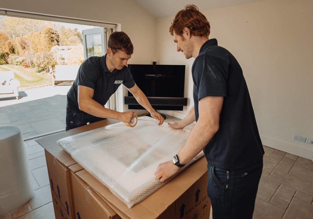 Roy Trevor team packing artwork and pictures