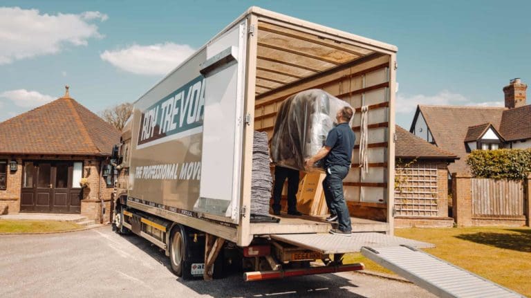 Roy Trevor team loading in a sofa to the lorry