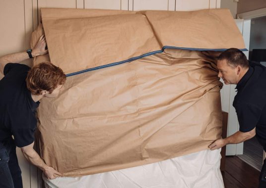 roy trevor team packing large item for export