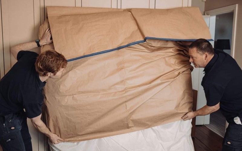 roy trevor team packing large item for export