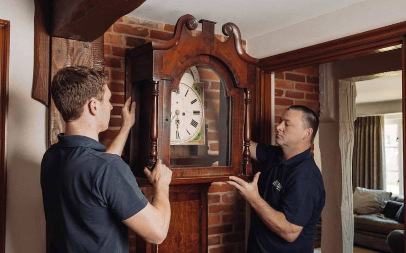 Roy Trevor team moving a grandfather clock